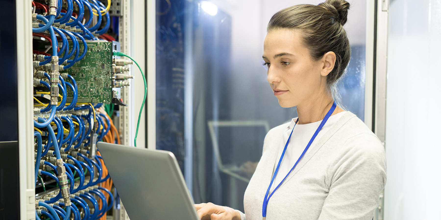 An IT professional types on their laptop computer. 