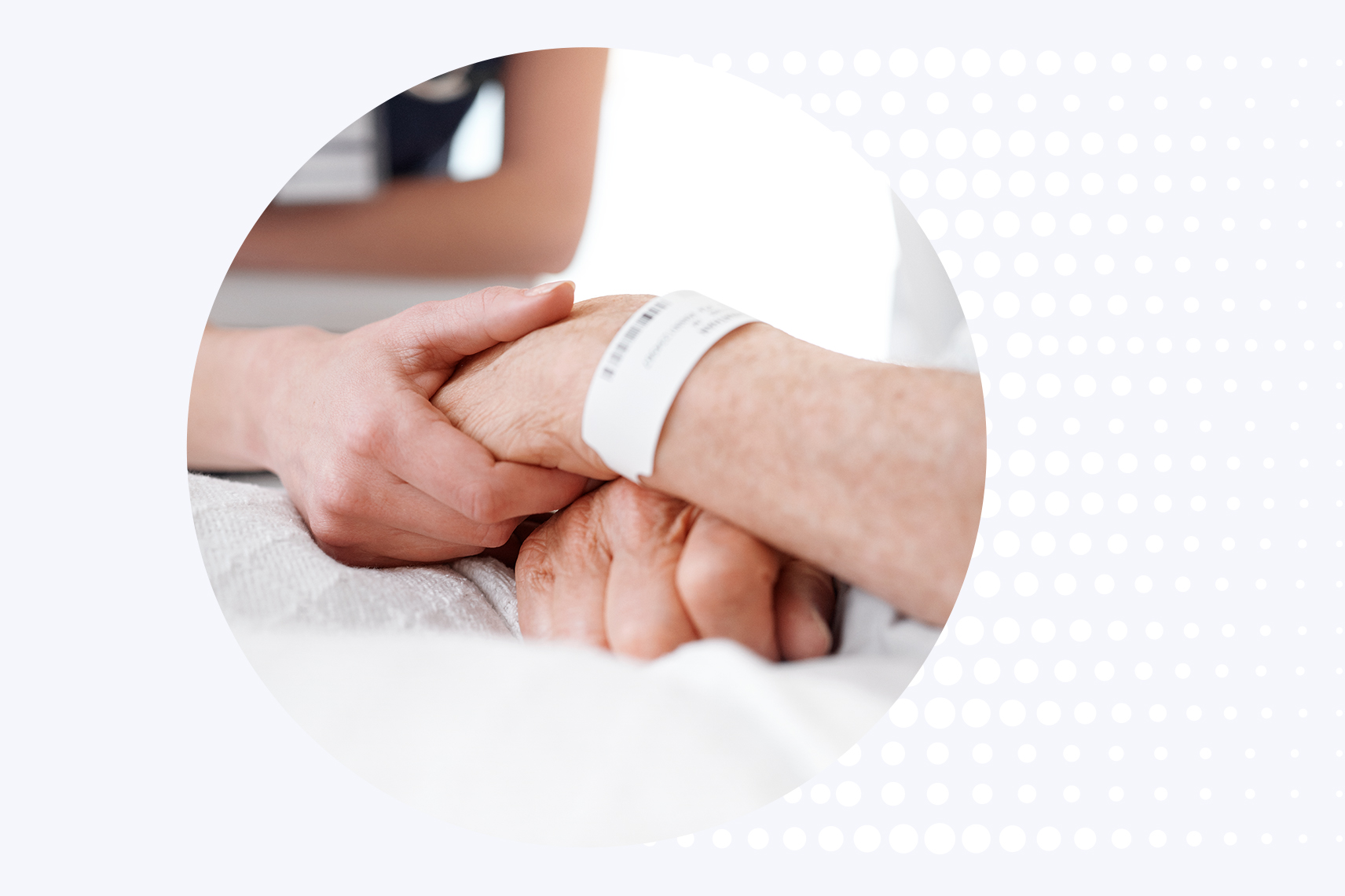 A nurse supports a patient’s hand while taking an SpO2 reading in an ICU setting